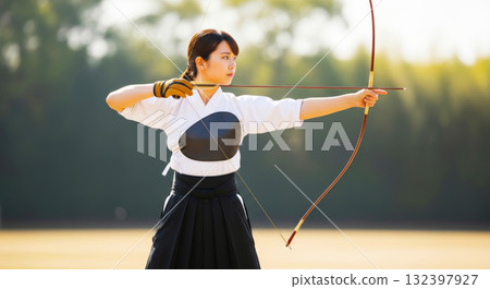 A woman practicing Kyudo 132397927