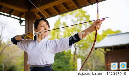 A woman practicing Kyudo 132397948