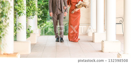 Wedding reception, after-party, bride and groom appearing in wedding color dresses, dressed-up couple 132398508