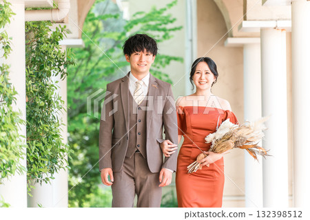 Wedding reception, after-party, bride and groom appearing in wedding color dresses, dressed-up couple 132398512