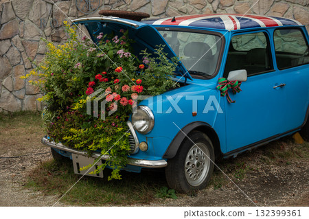 A blue classic car decorated with flowers 132399361