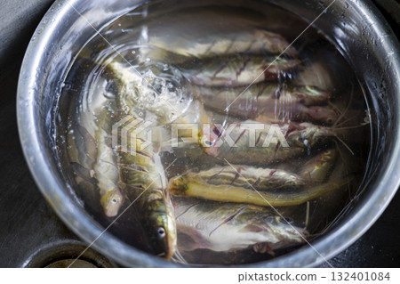 Variety Of Freshwater Fish Being Washed In Basin, A mix of freshwater fish is cleaned in a basin, water splashing with vitality, great for a vivid photo or a nature inspired visual promotion. Variety Of Freshwater Fish Being Washed In Basin, A mix of freshwater fish is cleaned in a basin, water splashing with vitality, great for a vivid photo or a nature inspired visual promotion. 132401084