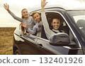 Smiling Family Waving During Nature Car Journey 132401926