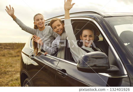 Smiling Family Waving During Nature Car Journey 132401926