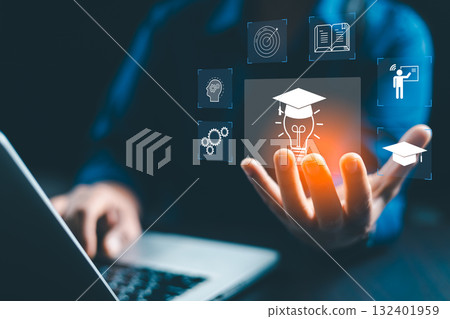 Concept of online education and digital learning is illustrated by hand using laptop, surrounded by icons such diploma, brain, target-symbolizing ideal e-learning platforms on education, development 132401959