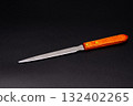 Paper knife on a black background 132402265