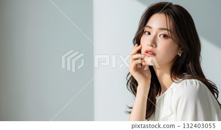 Portrait of a young woman with long hair and white clothes smiling in natural light Portrait of a young woman with long hair and white clothes smiling in natural light 132403055