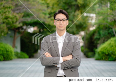 Smiling businessman with arms crossed Smiling businessman with arms crossed 132403569