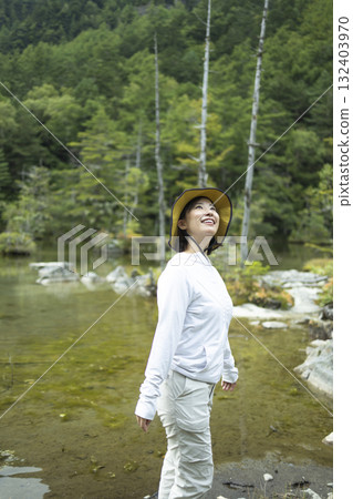 A woman enjoying mountain climbing 132403970