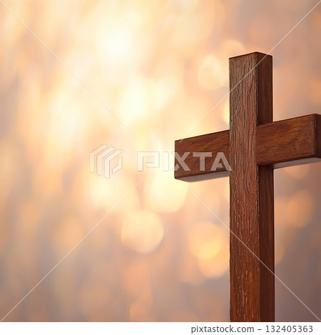 Wooden cross is shown against a background of blurry, glowing light 132405363