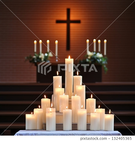 Lit candle arrangement in a church with a cross in the background 132405365
