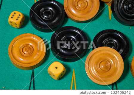 Black and yellow backgamon pieces and dice 132406242