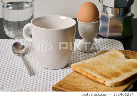 cup of coffee, egg and toast on black furniture 132406254