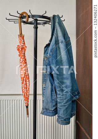 coat rack, umbrella, jacket against white wall coat rack, umbrella, jacket against white wall 132406271