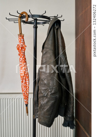 coat rack, umbrella, jacket against white wall coat rack, umbrella, jacket against white wall 132406272