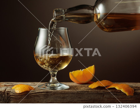 Old Fashioned cocktail with ice and orange peel on a old wooden table. Old Fashioned cocktail with ice and orange peel on a old wooden table. 132406394