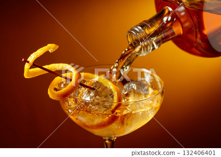 Old-fashioned cocktail garnished with orange peel. Old-fashioned cocktail garnished with orange peel. 132406401