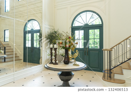 Foyer space with reception console in new luxury home with staircase. Foyer space with reception console in new luxury home with staircase. 132406513