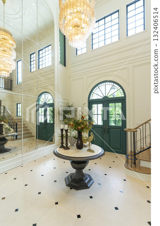 Foyer space with reception console in new luxury home with staircase. Foyer space with reception console in new luxury home with staircase. 132406514