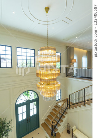 An elaborate, crystal chandelier in a hotel lobby or luxury home. An elaborate, crystal chandelier in a hotel lobby or luxury home. 132406587