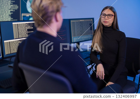 Team of cybersecurity professionals collaborating in a technology operations center. Team of cybersecurity professionals collaborating in a technology operations center. 132406997