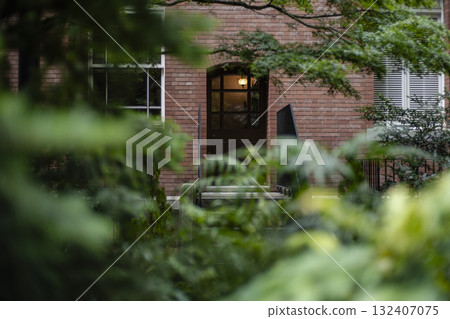 Green garden and brick building Green garden and brick building 132407075