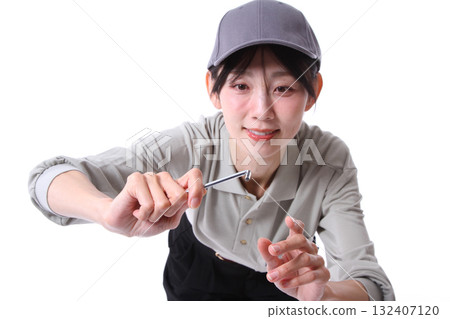 A woman working with a hex wrench 132407120