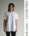 White Tshirt mockup, Woman modeling plain white Tshirt in neutral studio setting for branding 132407860