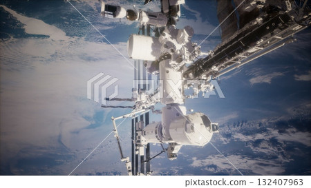 Under the mesmerizing view of Earth, the International Space Station hovers silently, showcasing human innovation in low Earth orbit while astronauts conduct vital experiments. 132407963