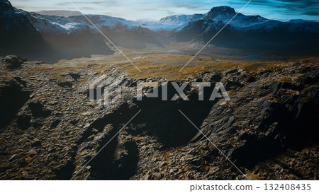 Vast expanse of mountains reveals jagged rocks and gentle slopes under a tranquil sky. The sunlight casts soft shadows across this serene wilderness, inviting exploration and adventure. Vast expanse of mountains reveals jagged rocks and gentle slopes under a tranquil sky. The sunlight casts soft shadows across this serene wilderness, inviting exploration and adventure. 132408435