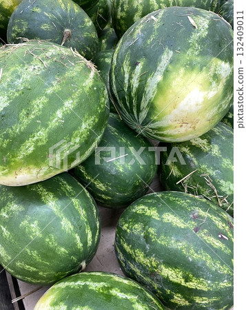 Watermelons displayed at a market stall, showcasing fresh produce and healthy eating concept Watermelons displayed at a market stall, showcasing fresh produce and healthy eating concept 132409011