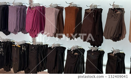 Gloves displayed in various colors and styles on hangers in store setting Gloves displayed in various colors and styles on hangers in store setting 132409041