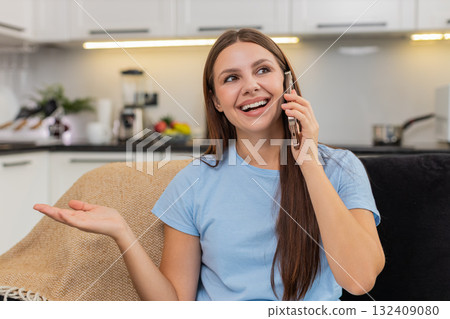 Young woman enjoys smartphone call smiles listens speaks in lively chat friendly voice and warm mood Young woman enjoys smartphone call smiles listens speaks in lively chat friendly voice and warm mood 132409080