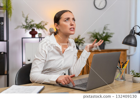 Young businesswoman sees laptop hang presses keys but computer fails to respond frustrated halt hard 132409130