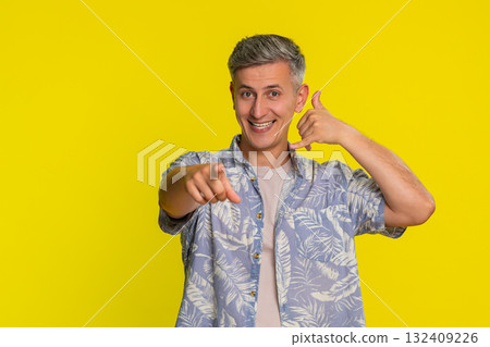 Man smiling and showing hand phone gesture near ear clearly signaling call me contact expression 132409226