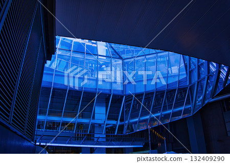 A view of an office district looking up at skyscrapers in a futuristic city A view of an office district looking up at skyscrapers in a futuristic city 132409290