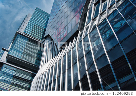 A view of an office district looking up at skyscrapers in a futuristic city A view of an office district looking up at skyscrapers in a futuristic city 132409298
