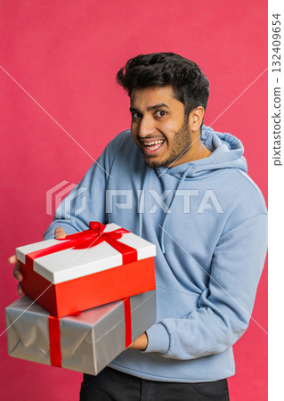 Smiling man presenting birthday gift present box stretches out hands, promotion discount sale Smiling man presenting birthday gift present box stretches out hands, promotion discount sale 132409654