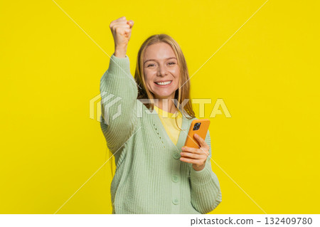 Happy excited winner woman use smartphone celebrating success winning play game good lottery news 132409780