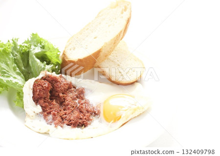 Breakfast: fried eggs, corned beef, and French bread Breakfast: fried eggs, corned beef, and French bread 132409798