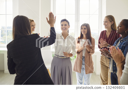 Happy women colleagues giving high five on meeting in office celebrating business achievement. Happy women colleagues giving high five on meeting in office celebrating business achievement. 132409801