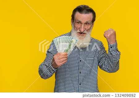 Rich happy senior man winner waving money dollar cash like a fan, big income wealth success business 132409892