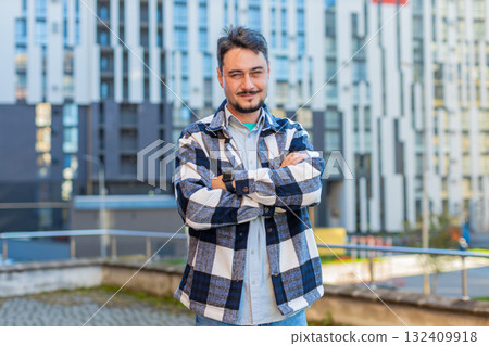 Portrait of happy Caucasian mature man looking at camera standing arms crossed on street Portrait of happy Caucasian mature man looking at camera standing arms crossed on street 132409918