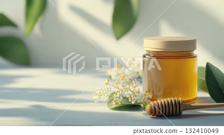 Natural rustic honey jar with hexagonal texture glows linden blossom, decorated with white blossoms and wooden spoon. Natural rustic honey jar with hexagonal texture glows linden blossom, decorated with white blossoms and wooden spoon. 132410049