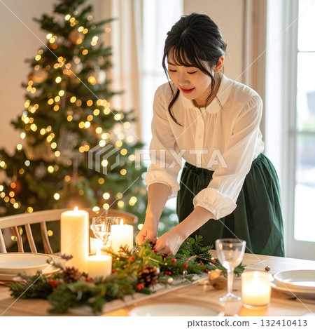 Warm winter portrait of a Japanese woman setting the table for Christmas dinner 132410413