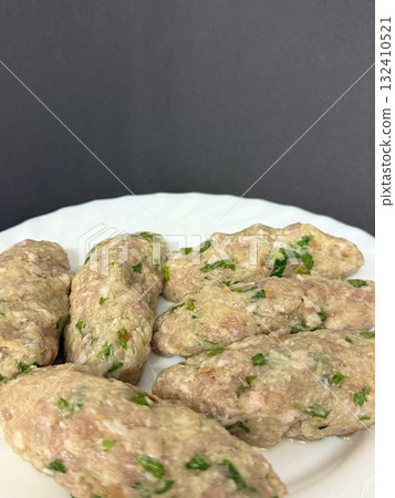 Close-up of raw meat keftedes. Traditional Cypriot food, Mediterranean cuisine. 132410521