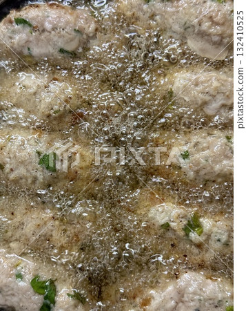 Close-up of raw meatballs being deep-fried. Traditional Cypriot food, Mediterranean cuisine. 132410525