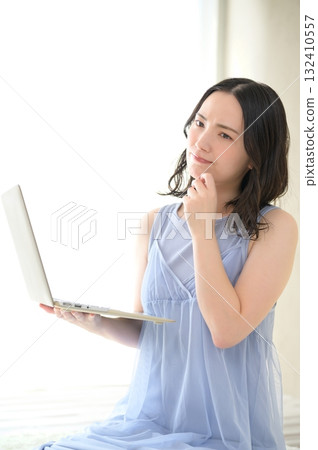 A woman troubled watching a personal computer A woman troubled watching a personal computer 132410557