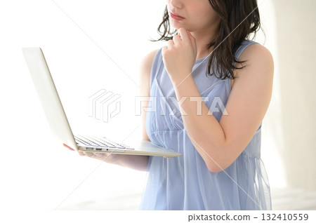 A woman troubled watching a personal computer A woman troubled watching a personal computer 132410559