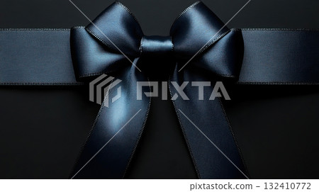 Elegant black satin ribbon in a bow shape on a black background, symbolizing mourning or grief. Elegant black satin ribbon in a bow shape on a black background, symbolizing mourning or grief. 132410772